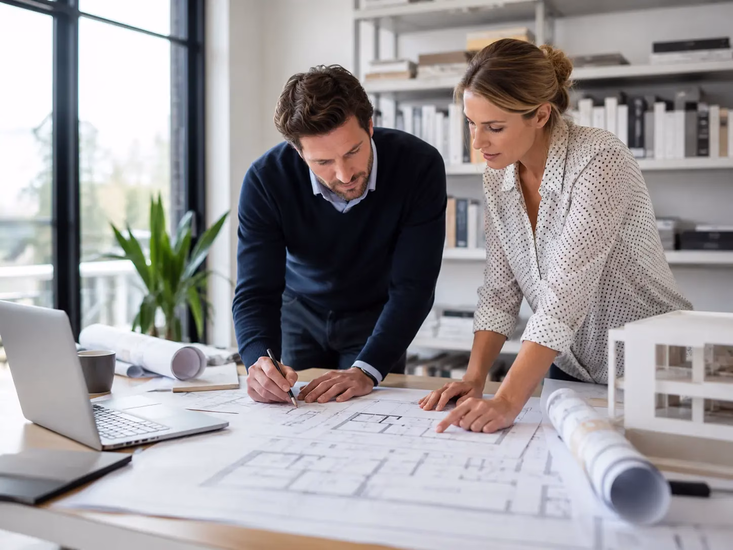 architects working on printed drawings from a measured building survey