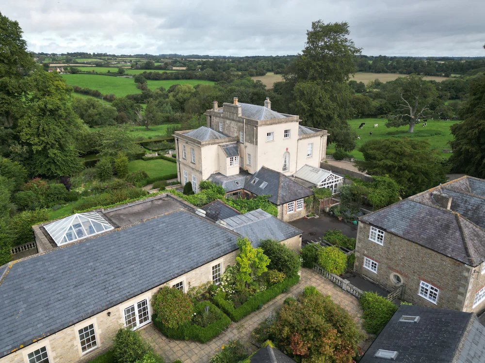 Aerial drone surveys showing a country estate, historic buildings, roofs and surrounding land in the South West
